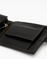 Midtown Lite wallet outer snap pocket open — black sheep leather detail