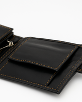 Midtown Lite wallet outer snap pocket open — black sheep leather detail