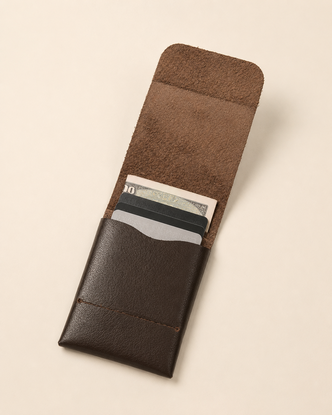 The Seamless wallet open — single compartment holding cards and cash