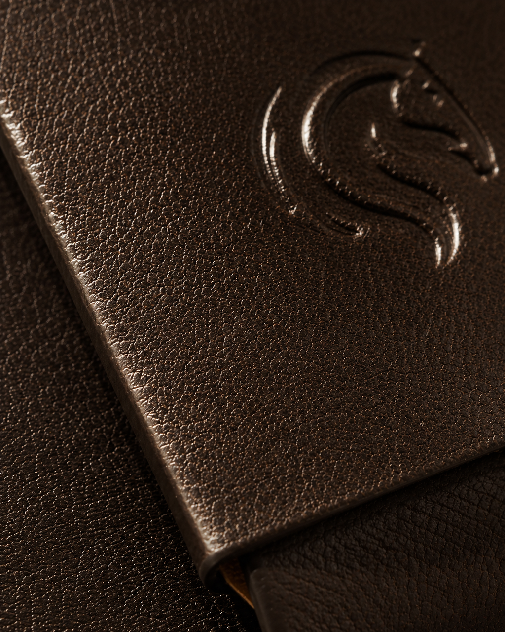 Close-up of the seamless single-piece brown leather construction