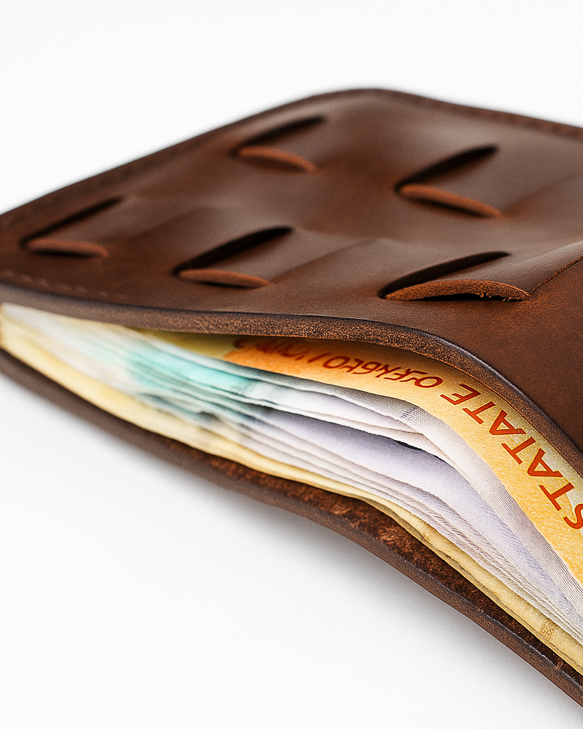 Brown leather wallet with money and cards on a white background