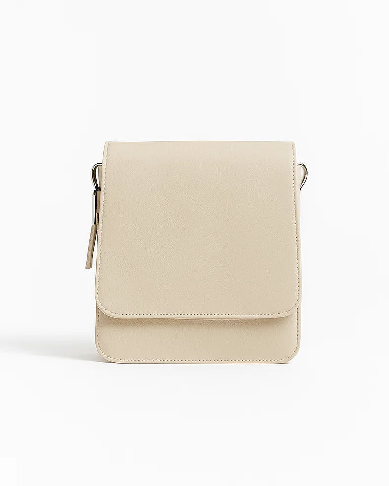 Beige crossbody bag on a white background