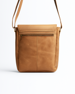 Tan leather crossbody bag on a white background