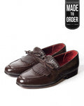 A pair of brown natural milled leather tassel loafers with a soft leather inner lining and a stitched outer leather sole.