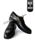 A pair of black premium oxford leather shoes with a lace-up closure, displayed against a white background with a 'Made to Order' label.