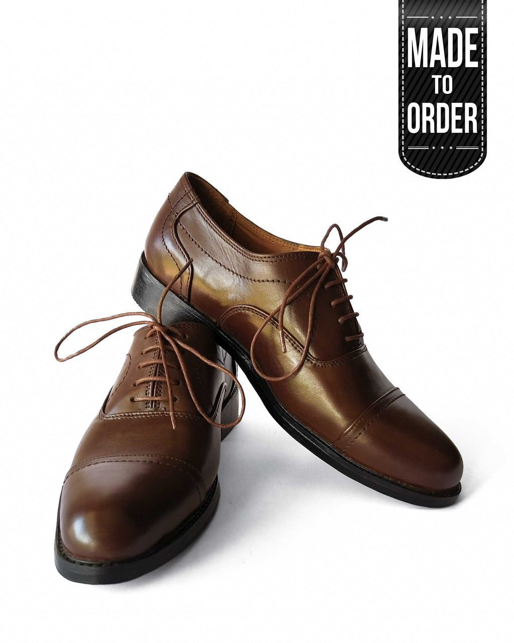 A pair of brown Kordovan premium oxford leather shoes with lace-up closure, displayed against a white background with a 'Made to Order' label.
