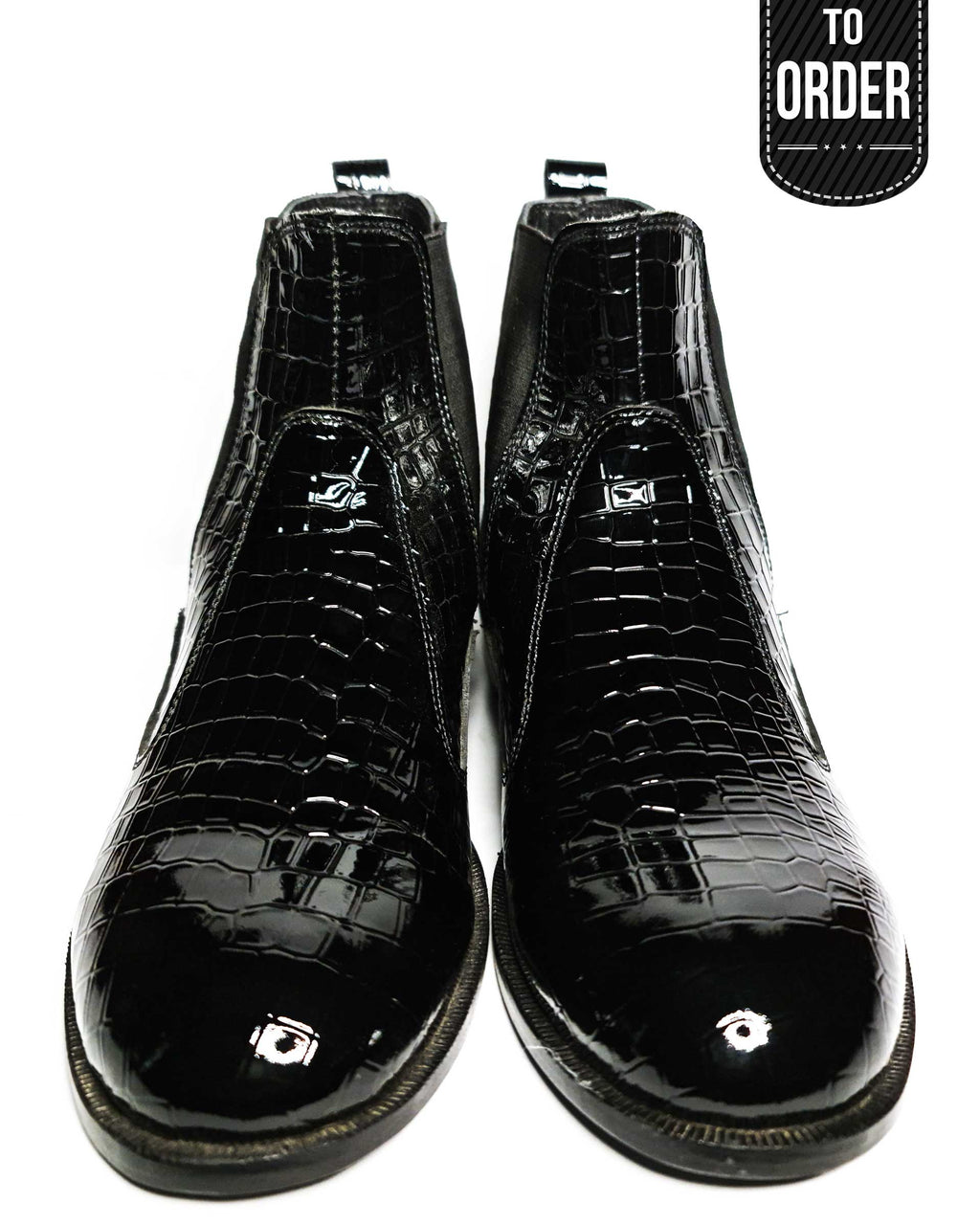 A pair of black, premium leather boots with a textured design and a small decorative embellishment on the sole.